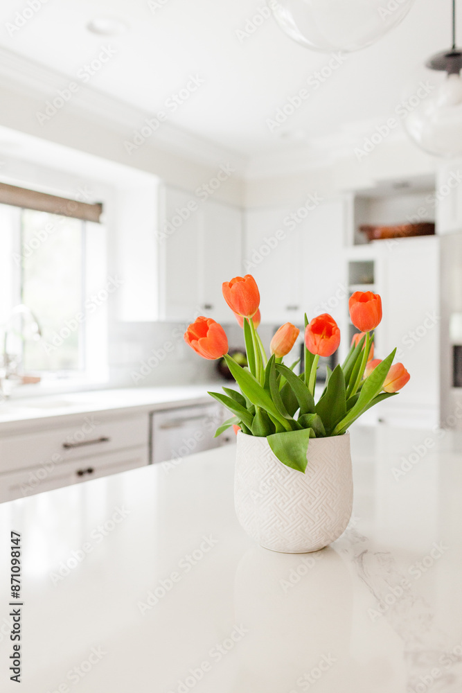 Orange Tulips on Quartz Countertop in White Kitchen Orange Tulips on Quartz Countertop in White Kitchen
