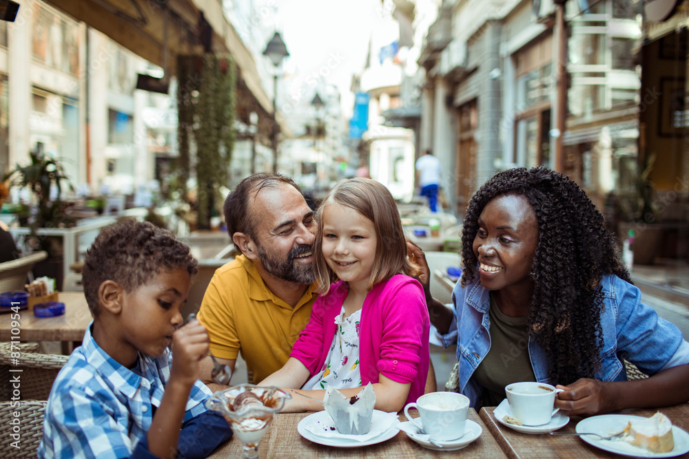Happy multiethnic family enjoying time at a cafe together Happy multiethnic family enjoying time at a cafe together
