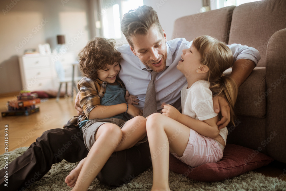 Happy father playing with son and daughter at home Happy father playing with son and daughter at home