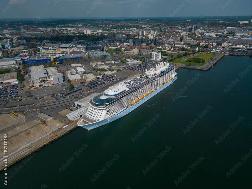 Naklejka premium Large cruise ship moored at Southampton UK. Panoramic view of the urban Southampton city with cruise ship terminal. High altitude aerial on a sunny day.