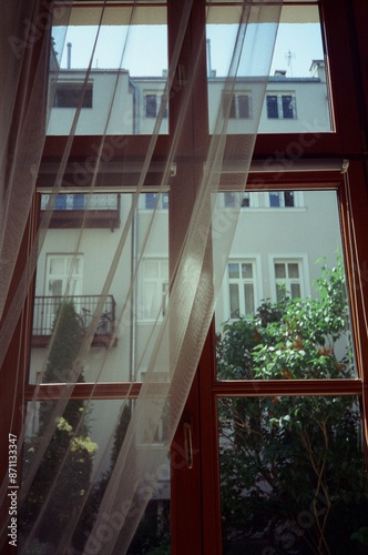 A Window With Fluttering Curtains