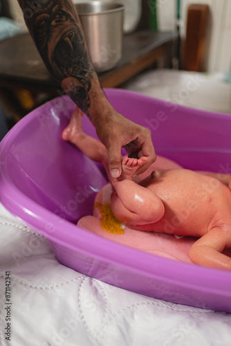 Baby pooping during bathing. photo