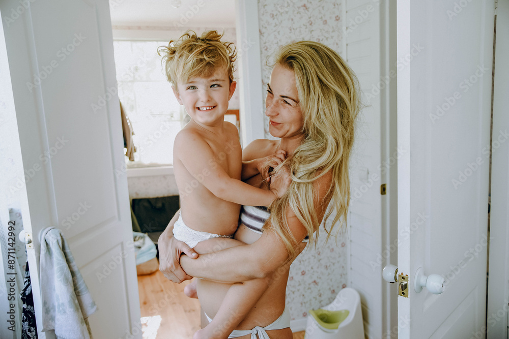mother hugs the boy in the room mother hugs the boy in the room