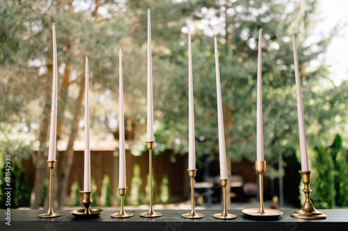 Tall White Candles in Brass Candle Holders for Wedding Decor photo