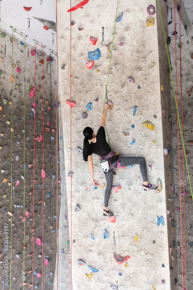 Young Woman Climbing Indoors Young Woman Climbing Indoors