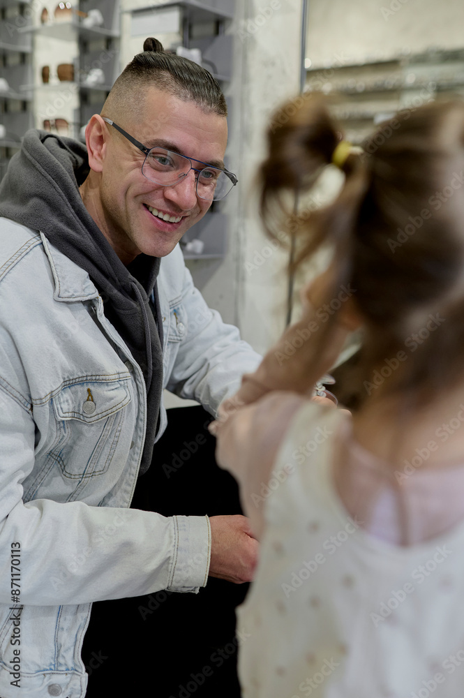 Dad chooses glasses with his child