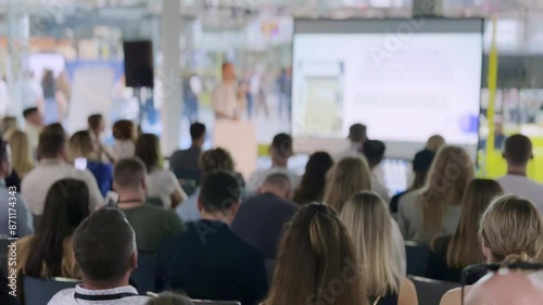 Wallpaper Mural Large group of people listening to a business presentation in a modern conference room. The audience is focused on the speaker and the presentation displayed on screen. Torontodigital.ca