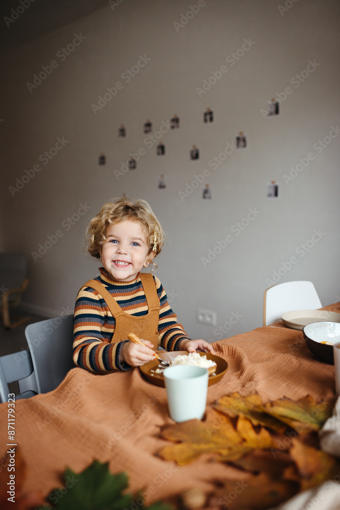 Smiling child enjoying a snack at birthday event Smiling child enjoying a snack at birthday event