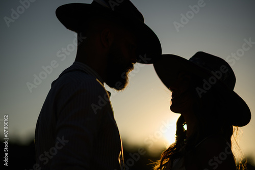Photos Silhouette of rancher couple at homestead flirting outdoors at sunset