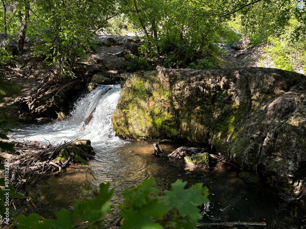 Waterfall next to Hobbit caves in Logan Canyon Utah, early summer in forest Waterfall next to Hobbit caves in Logan Canyon Utah, early summer in forest