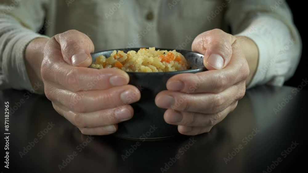 Immigrant hands with food bowl. An immigrant suffer from hungry period with a bowl of porridge indoor. Immigrant hands with food bowl. An immigrant suffer from hungry period with a bowl of porridge indoor.