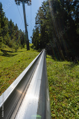 Metal Slide Rail Way Leading Through the Forest Floor near a Cable Car Lift