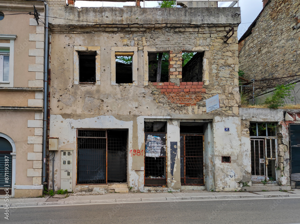 A house in Mostar, Bosnia and Herzegovina, ruined during the Bosnian War, left with traces of gunshots, as a war memorial. A house in Mostar, Bosnia and Herzegovina, ruined during the Bosnian War, left with traces of gunshots, as a war memorial.