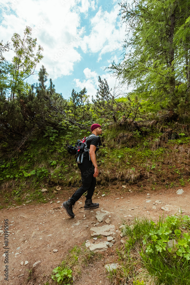 Obraz premium Climber Hiking up the Mountain Trail