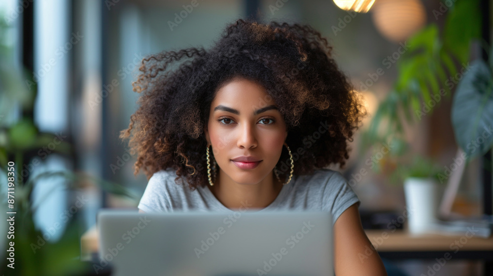Focused Young Businesswoman Working on Laptop in Modern Office - Professional Female with Natural Hair - Ideal for Business, Technology, and Productivity Themes Focused Young Businesswoman Working on Laptop in Modern Office - Professional Female with Natural Hair - Ideal for Business, Technology, and Productivity Themes