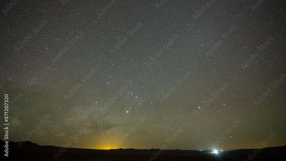 Milky Way time lapse along a highway with passing cars in Nevada 