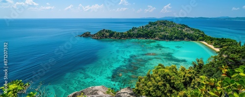 Stunning aerial view of a tropical island surrounded by turquoise water, lush greenery, and a pristine sandy beach under a clear blue sky.