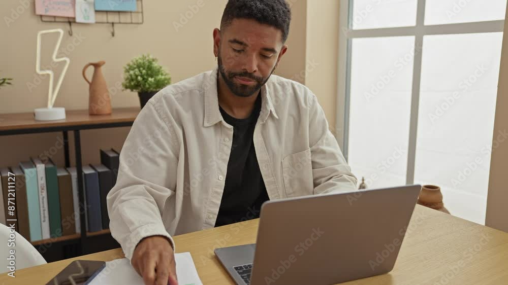 Stressed young man with beard working on laptop in home office with headache Stressed young man with beard working on laptop in home office with headache