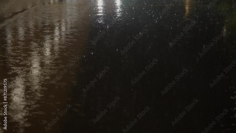 The rain falls heavily on the dark road The rain falls heavily on the dark road