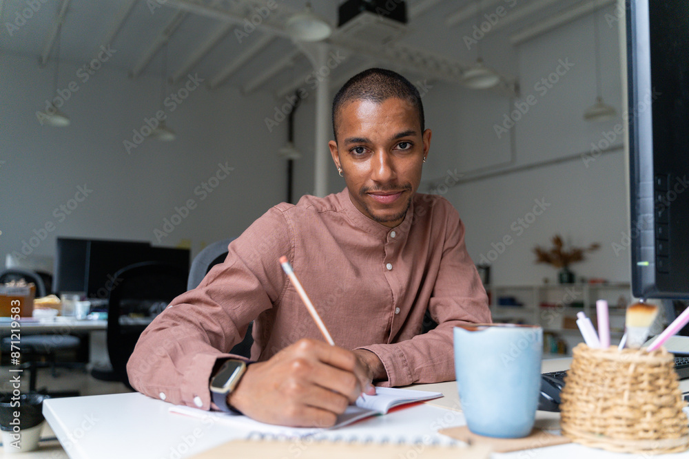 Queer man working at office Queer man working at office