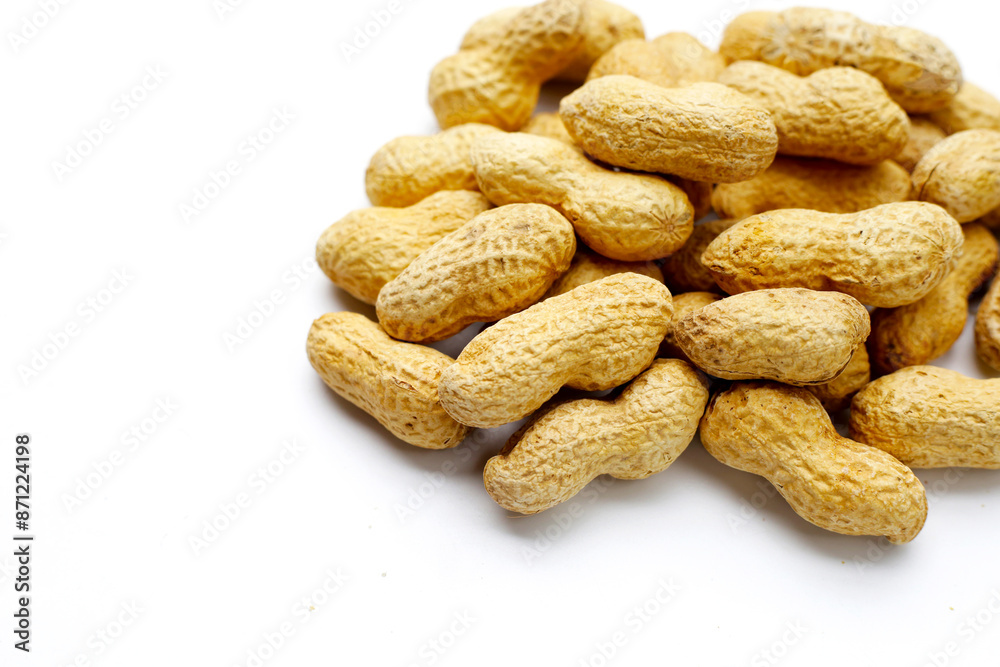Roasted peanuts in shell on white background.