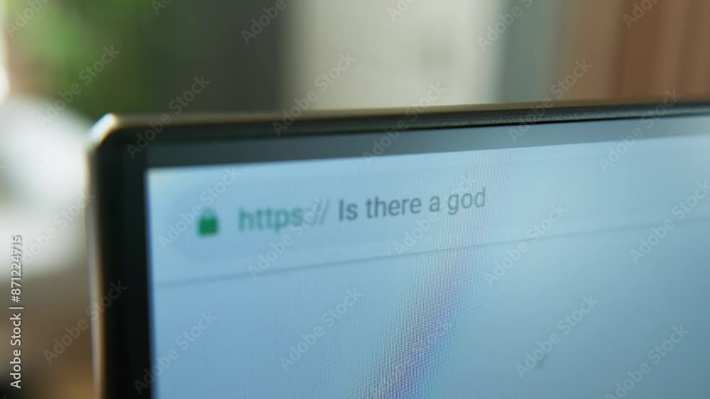 A close-up shot of a computer monitor displaying a web browser, focusing on the address bar and URL. Searching in browser ''is there a god?''