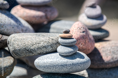 Various sizes and colors pebbles stacked on a beach