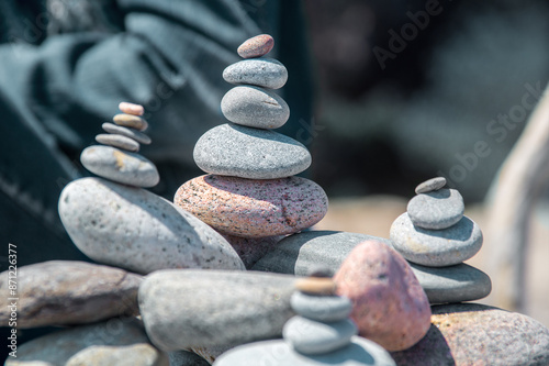 Various sizes and colors pebbles stacked on a beach