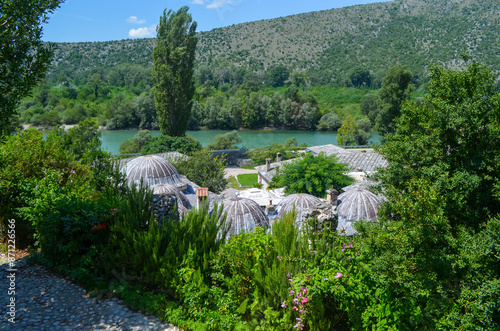 Scenic View of a Historic Village with River and Hills
