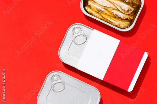 Canned sardines mockup flat lay on red background photo