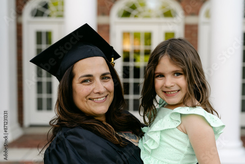 middle aged happy college graduate with her daughter 