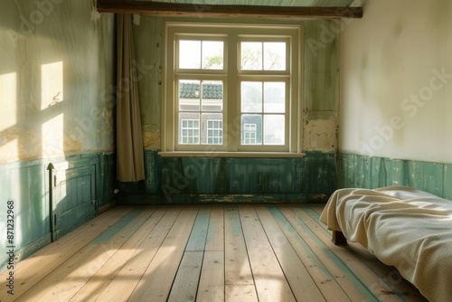 Interior of an old abandoned house with green walls and wooden floor