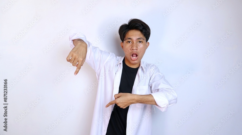 shocked young Asian man gesturing pointing down shocked young Asian man gesturing pointing down