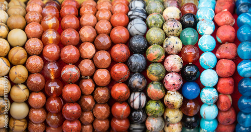 A row of colorful beads are displayed in a row