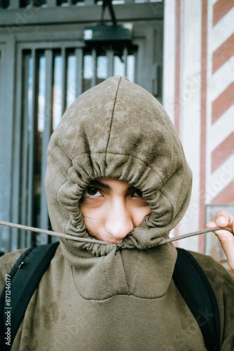 Hooded Person Pulling Drawstring Tight photo