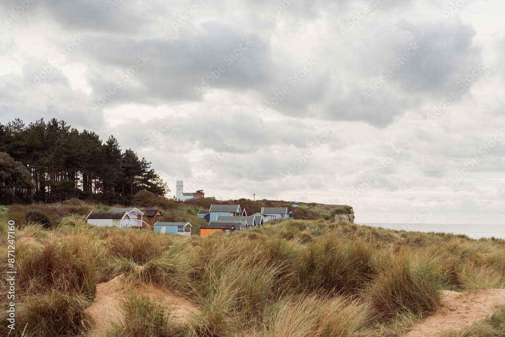 Old Hunstanton beach huts and lighthouse in Norfolk Old Hunstanton beach huts and lighthouse in Norfolk