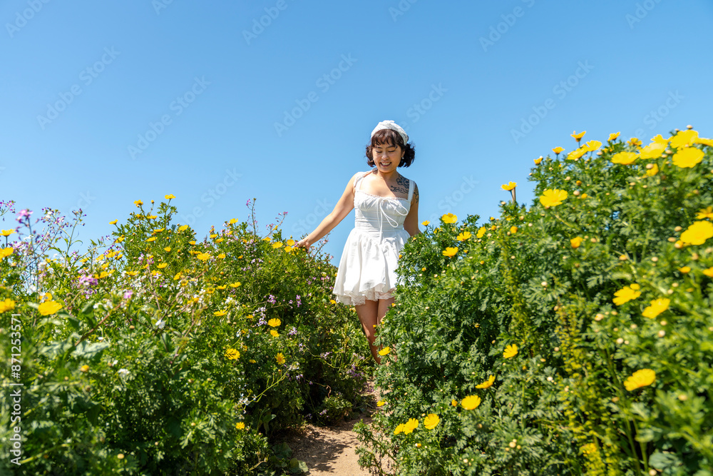 Beautiful woman walking amongst wildflowers Beautiful woman walking amongst wildflowers