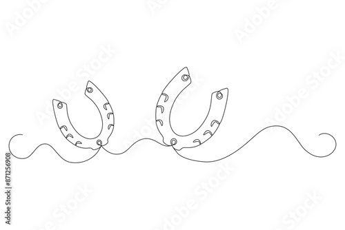Horseshoes for luck are drawing as one continuous line in minimalism. Editable vector contour