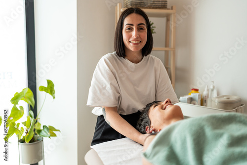 Female masseuse smiling.