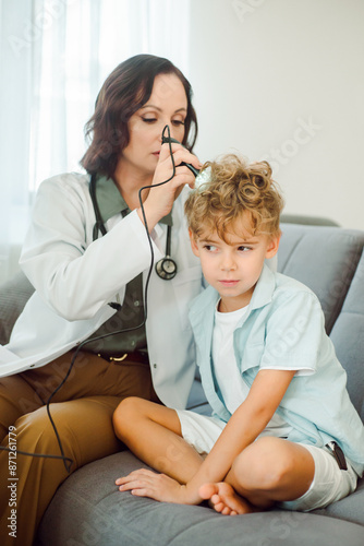 Pediatrician checks the boy's head for skin diseases and lice. photo