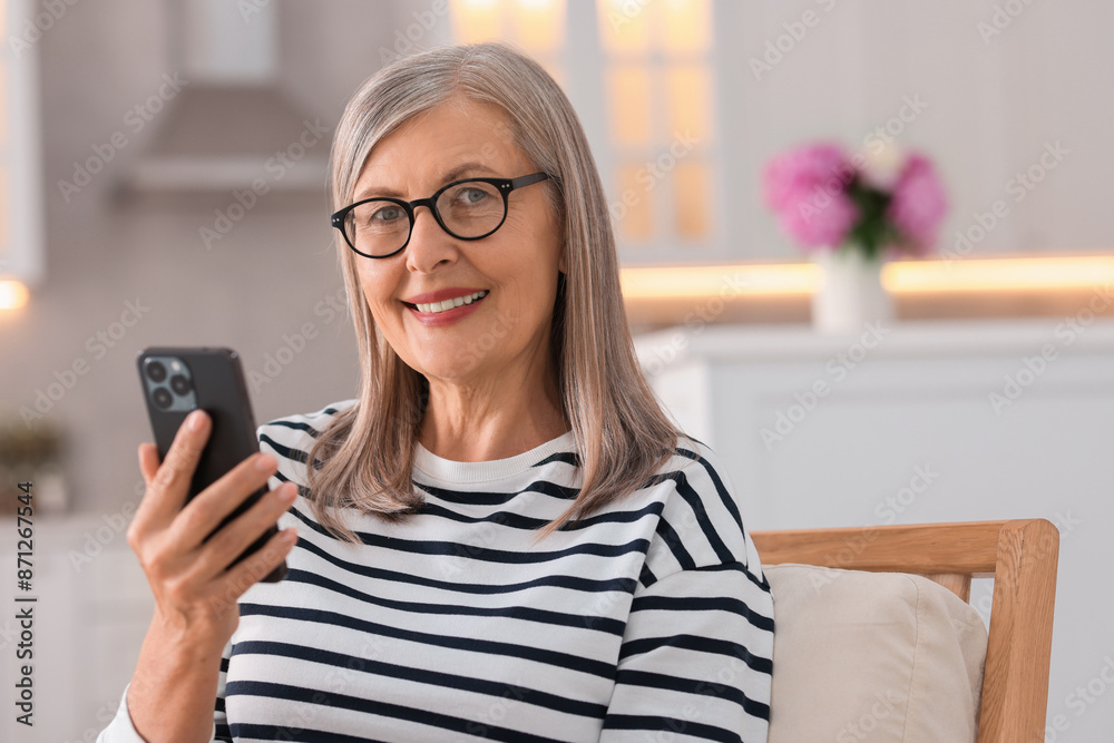 Senior woman using mobile phone at home Senior woman using mobile phone at home