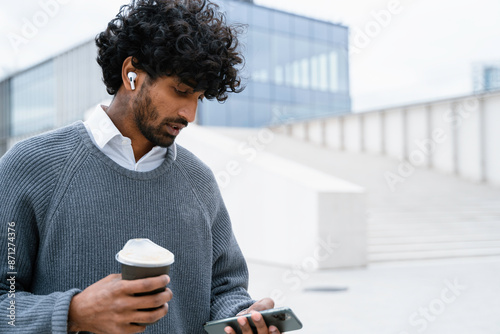 A man uses a mobile phone in the city
