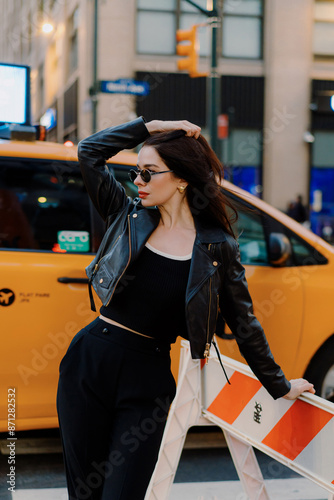 Stylish woman on city street by taxi, exudes chic, elegant lifestyle