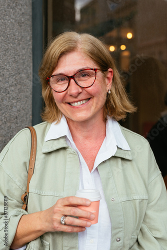 Senior woman smiling with a coffee in the hand