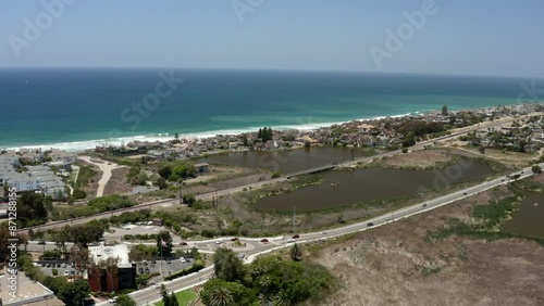 Aerial view Carlsbad Batiquitos Lagoon and bridge crossing on a sunny day in San Diego California with blue sky and wetlands by the Pacific Ocean off highway 101 photo