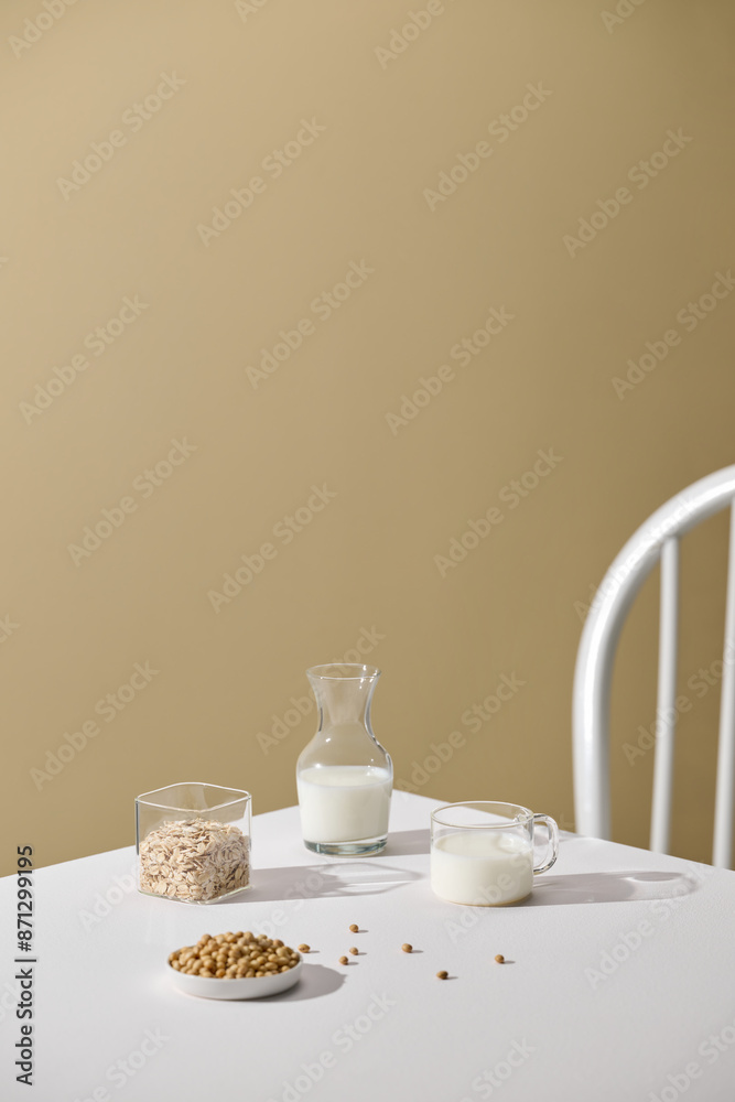 Different vegan milks and ingredients on a white table Different vegan milks and ingredients on a white table