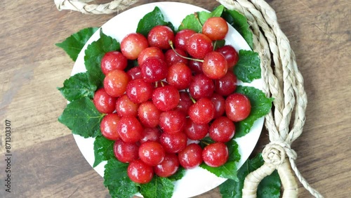 Top view Rotate Red Cherry fruit on wooden background, Japanese Red highest variety of Yamagata cherries on white table.