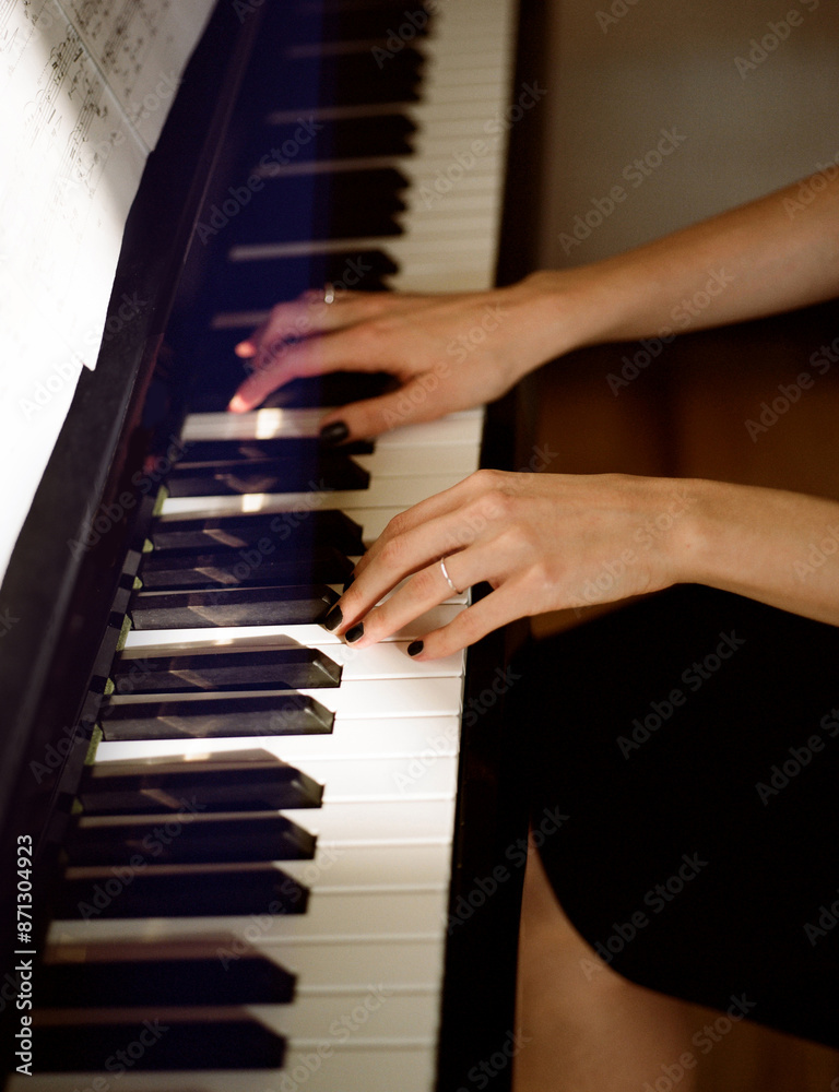 Woman playing the piano at home Woman playing the piano at home