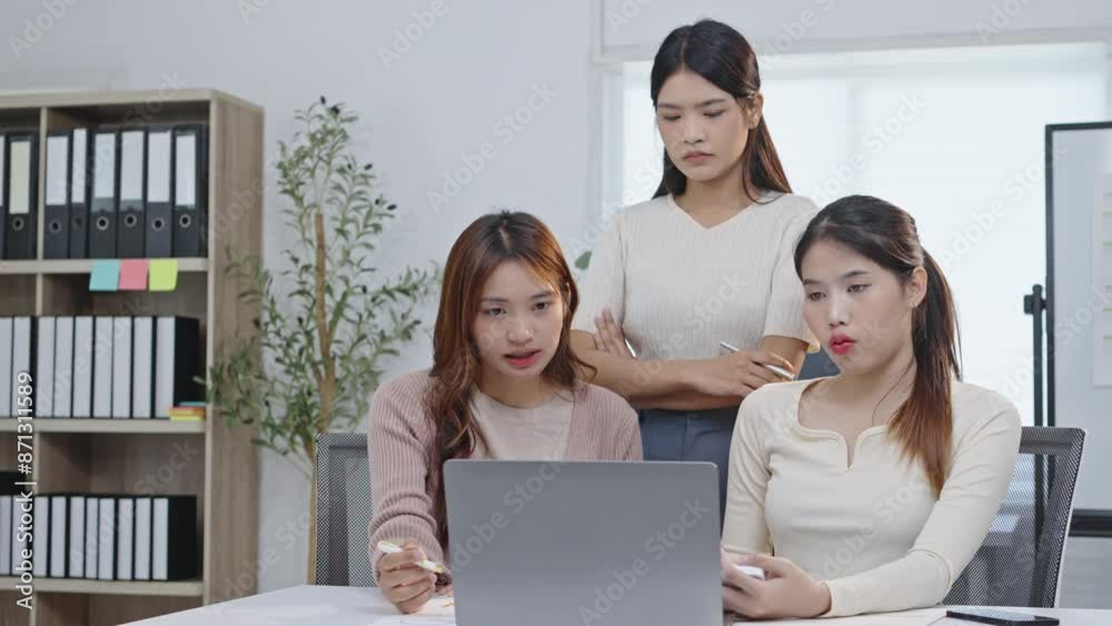 Three businesswomen collaborate on a project in a modern office, discussing ideas and analyzing data on a laptop Three businesswomen collaborate on a project in a modern office, discussing ideas and analyzing data on a laptop