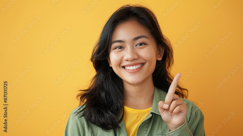 Indonesian women or Asian Woman pointing finger to blank copy space with smile face. beautiful, happy, joy and posing cheerful mood. isolated on background Indonesian women or Asian Woman pointing finger to blank copy space with smile face. beautiful, happy, joy and posing cheerful mood. isolated on background